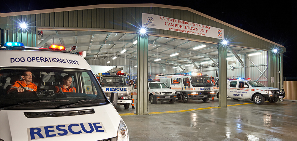 Dog Operations Unit vehicle in front of the SA State Emergency Service Campbelltown Unit building with SES rescue vehicles inside it